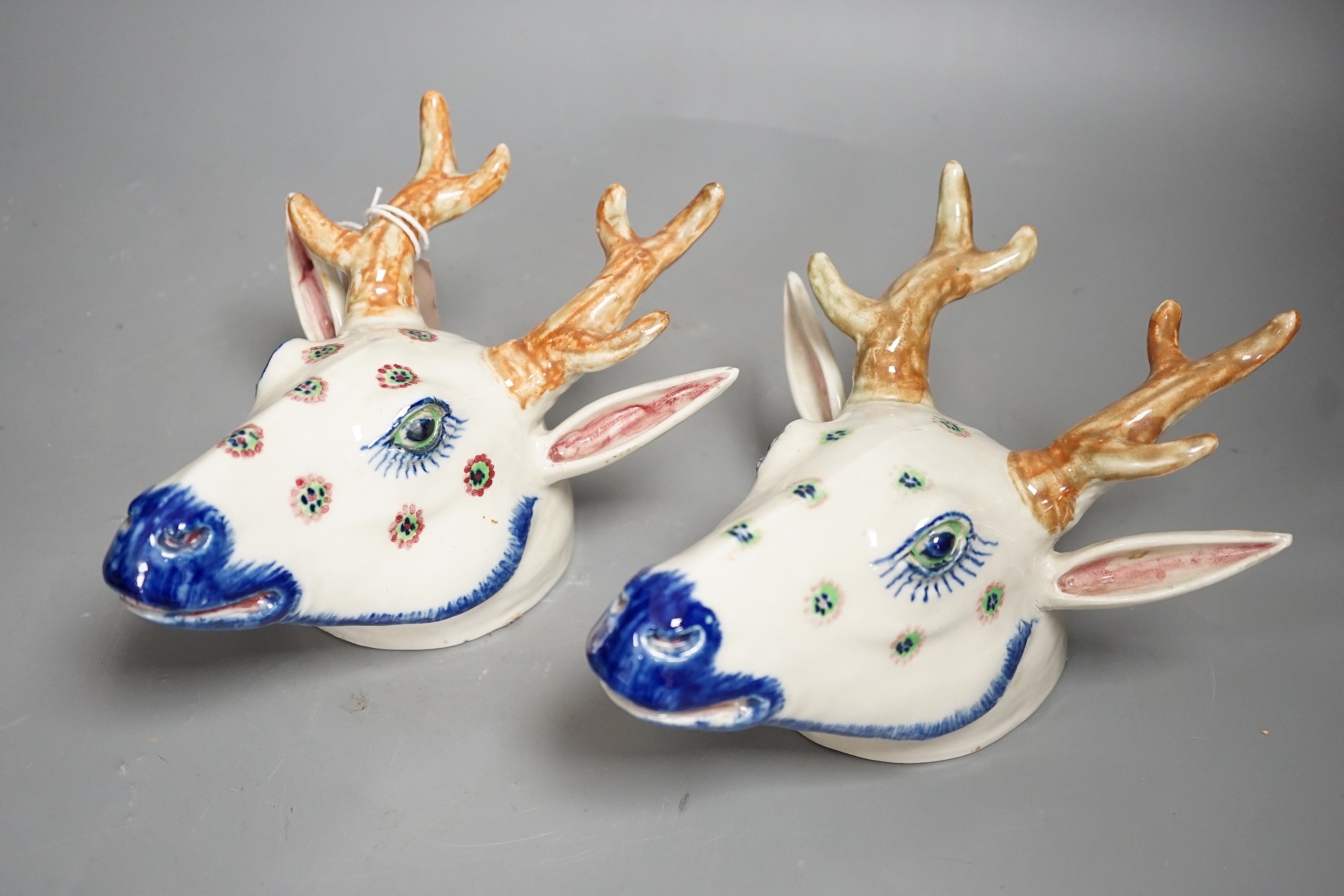 Two Continental pottery stag head wall pockets, 22cms high